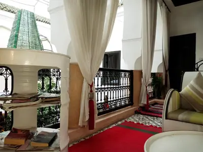a living room with a couch and a balcony at Riad Gaya in Marrakech