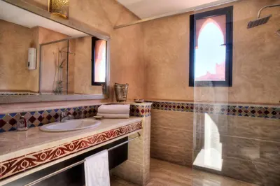 a bathroom with a sink and a mirror at Villa Tilila in Marrakech