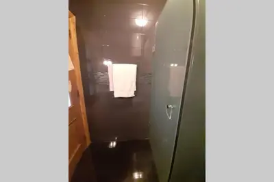 a bathroom with a shower with a towel on the wall at Hivernage - Stylish APT in the Heart of the City in Marrakech