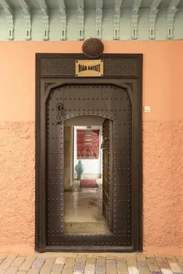a door in a wall with a sign on it at Riad Hayati in Marrakech