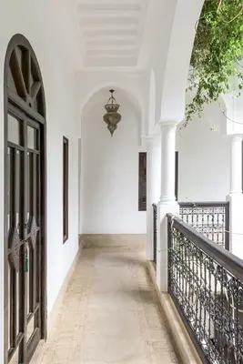 a hallway of a house with a gate and a chandelier at Riad Hayati in Marrakech