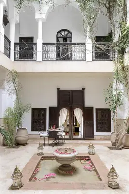 a large building with a fountain in a courtyard at Riad Hayati in Marrakech