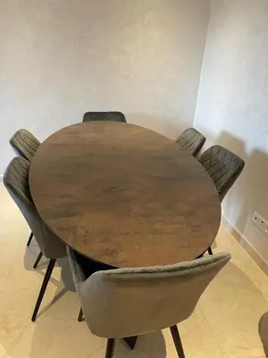 a wooden table with four chairs around it at La Perla de Marrakech Appart de Luxe in Marrakech
