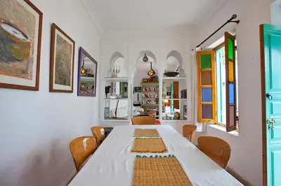 a dining room with a large white table and chairs at Riad Dar Aida in Marrakech
