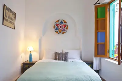 a bedroom with a bed with a clock on the wall at Riad Dar Aida in Marrakech