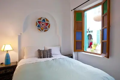 a bedroom with a bed with a clock on the wall at Riad Dar Aida in Marrakech