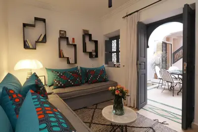 a living room with a couch and a table at Riad Dar Safi, privatise 6 à 8 pers, bain exterieur in Marrakech