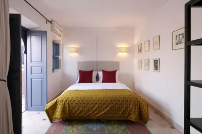a bedroom with a large bed with red pillows at Riad Dar Safi, privatise 6 à 8 pers, bain exterieur in Marrakech