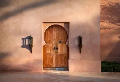 a wooden door on the side of a building at Amanjena Resort in Marrakech