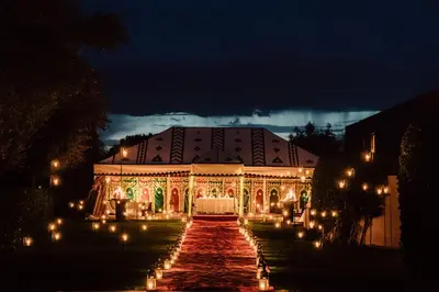 a large building with lights in front of it at night at Amanjena Resort in Marrakech