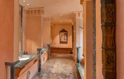 a bathroom with two sinks and a mirror at Amanjena Resort in Marrakech