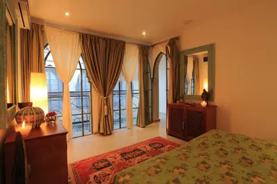 a bedroom with a bed and a large window at Riad Infinity Sea in Marrakech