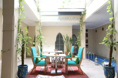 a dining room with a table and chairs at Riad Infinity Sea in Marrakech