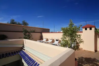 a balcony with lounge chairs on a building at Riad Infinity Sea in Marrakech