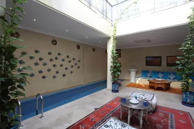 a living room with a glass ceiling and a table at Riad Infinity Sea in Marrakech