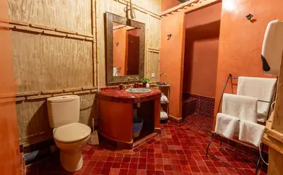 a bathroom with a toilet and a sink and a mirror at Les Sources berbères Riad & Spa in Marrakech