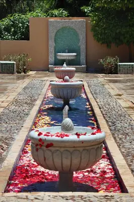 a fountain in the middle of a courtyard with flowers at Valeria Madina Club - All Inclusive in Marrakech