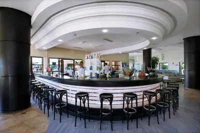 a bar in a restaurant with stools in a room at Valeria Madina Club - All Inclusive in Marrakech