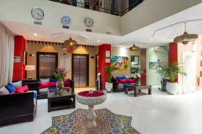 a living room with a couch and a table at Le Caspien Boutique Hotel in Marrakech