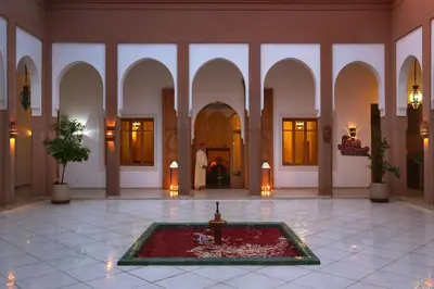 a room with a fountain in the middle of a building at Valeria Dar Atlas All Inclusive in Marrakech