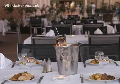 a table with plates of food and a bucket on it at Valeria Dar Atlas All Inclusive in Marrakech