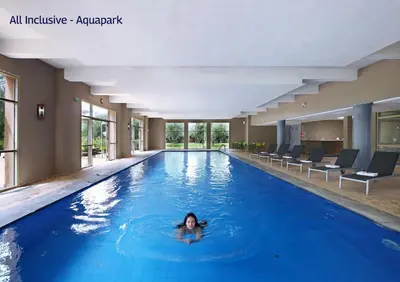 a woman swimming in a swimming pool at Valeria Dar Atlas All Inclusive in Marrakech