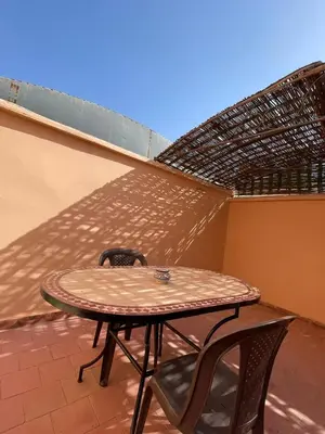a table and two chairs sitting on a patio at Riad NEJJARINE in Marrakech