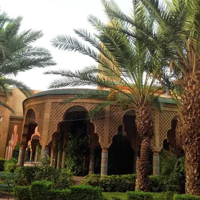 a building with a palm tree in front of it at Riad NEJJARINE in Marrakech