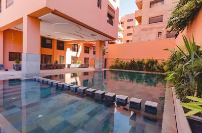 a swimming pool in front of a building at Stylish Studio(WiFi, Netflix, Pool, AC, Nespresso) in Marrakech