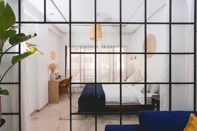 a room with a bed and a desk and a window at Stylish Studio(WiFi, Netflix, Pool, AC, Nespresso) in Marrakech