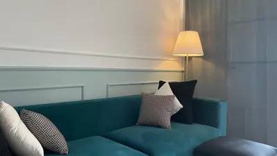 a green couch with pillows on it in a room at Chimera Apartments & Suites in Marrakech