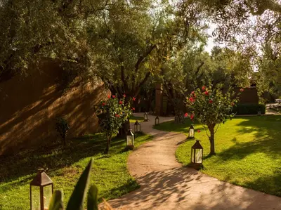 a walkway through a park with flowers and trees at CASA ABRACADABRA in Marrakech