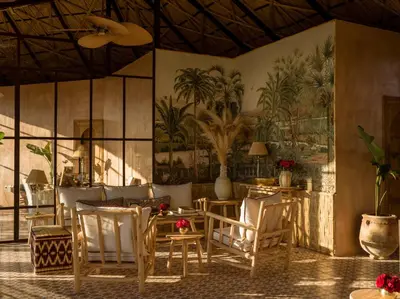 a dining room with tables and chairs and a mural at CASA ABRACADABRA in Marrakech