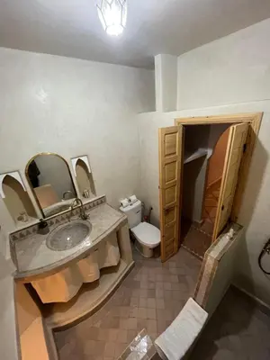 a bathroom with a sink and a toilet and a mirror at Riad Minami in Marrakech