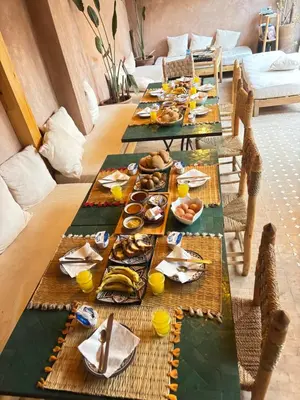 a long table with plates of food on it at Riad Minami in Marrakech