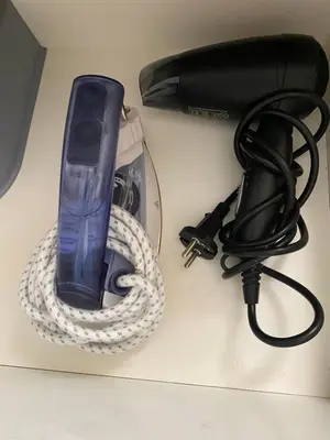 a hair dryer on a counter next to a blow dryer at Comme a la maison Prestigia Golf acces piscine in Marrakech
