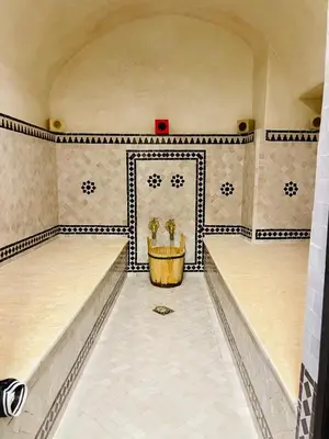 a room with a table in the middle of a wall at Riad Babouchta & Spa in Marrakech