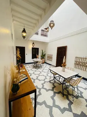 a large room with tables and chairs in it at Riad Babouchta & Spa in Marrakech