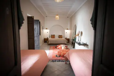 a bedroom with two beds and a room with two beds at Riad Babouchta & Spa in Marrakech
