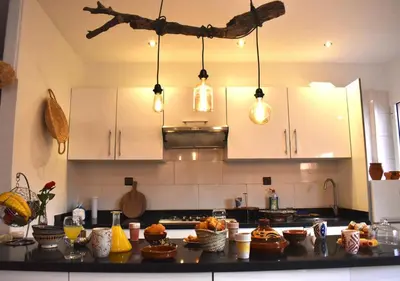 a kitchen with white cabinets and a counter with food on it at COSY LUXURY Apartment - GUELIZ in Marrakech