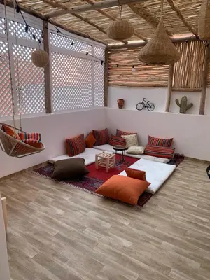 a living room with couches and tables in a room at COSY LUXURY Apartment - GUELIZ in Marrakech