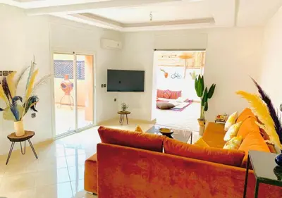 a living room with a couch and a tv at COSY LUXURY Apartment - GUELIZ in Marrakech