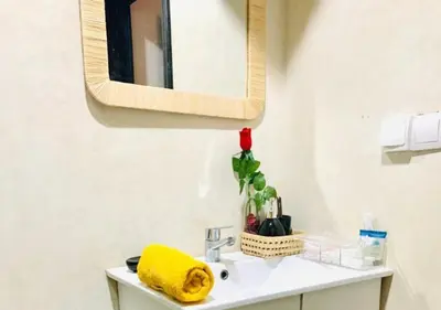 a bathroom with a sink and a mirror at COSY LUXURY Apartment - GUELIZ in Marrakech