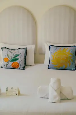 a bed with two pillows and a teddy bear on it at MORO Marrakech Boutique Hôtel in Marrakech