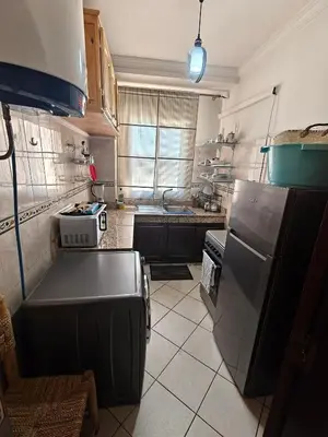 a kitchen with a stove and a refrigerator at Bright Air Conditioned Apartment Near City Center in Marrakech