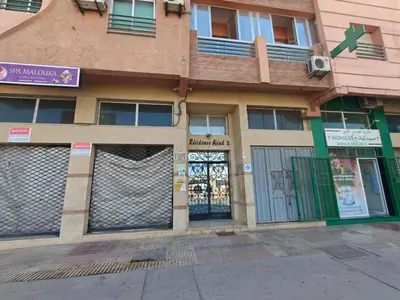 a building with the doors open on a street at Bright Air Conditioned Apartment Near City Center in Marrakech