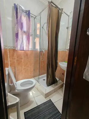 a bathroom with a toilet and a shower at Bright Air Conditioned Apartment Near City Center in Marrakech