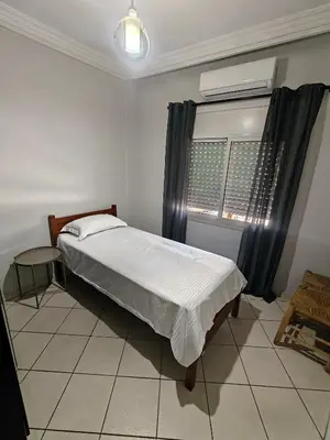 a bedroom with a bed and a window at Bright Air Conditioned Apartment Near City Center in Marrakech