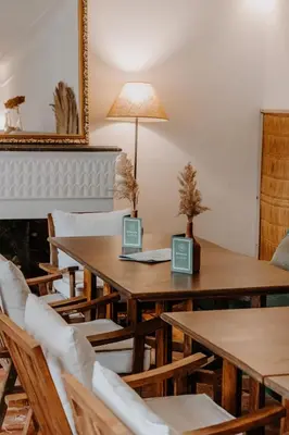 a dining room with wooden tables and chairs at Riad Agathe & Spa in Marrakech