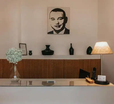 a desk with a picture of a man on the wall at Riad Agathe & Spa in Marrakech